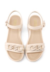 Sandali beige con un design a tracolla intrecciata, cinturino alla caviglia regolabile e texture in pelle liscia. Suole piatte e stile minimalista.