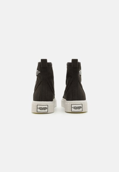 Black canvas high-top sneakers with a textured white sole, featuring back pull tabs and logo details in white on the sides.