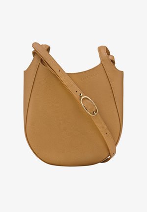 Tan leather shoulder bag with a round shape, a textured surface, a gold-tone hardware accent, and an adjustable strap.