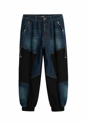 Dark blue denim and black jogger pants with zipper pockets and elastic cuffs.