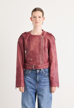 Red leather cropped jacket with zip closure and front pocket, featuring a belted waist and long sleeves with zippers at the cuffs.