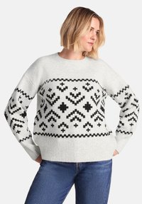 Light gray knitted sweater with black geometric patterns, ribbed cuffs, and hem. Boxy fit with dropped shoulders and textured fabric.