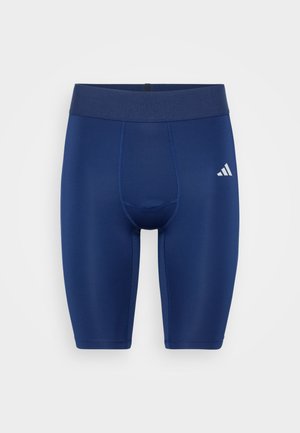 Granatowe sportowe szorty wykonane z elastycznego materiału, charakteryzujące się dopasowanym krojem, elastyczną talią oraz małym białym logo na dolnym prawym boku.