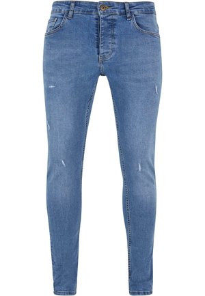 Jeans blu chiaro in denim, con una vestibilità slim, dettagli sfrangiati, cinque tasche e chiusura con bottoni.