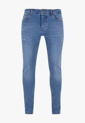 Jean bleu clair en denim, avec une coupe slim, des détails déchirés, cinq poches et une fermeture à boutons.