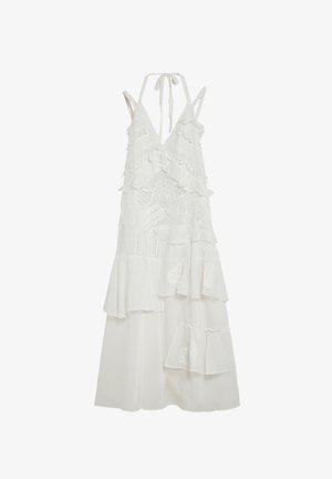 Robe blanche sans manches avec lien à nouer au cou, comportant des volants superposés et une broderie en dentelle complexe sur tout le tissu.