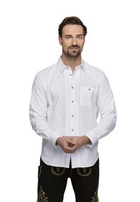 White long-sleeve shirt with button closure, featuring decorative vertical stitching and a chest pocket. Model wears dark pants with embroidery.