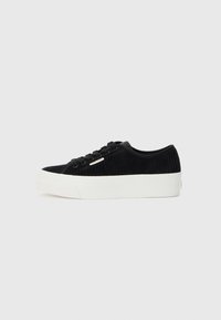 Black corduroy sneaker with a white rubber sole. Features round toe, lace-up front, and a minimal logo accent on the side.