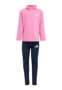 Růžová dlouhá zipová halenka s vysokým límcem, spárovaná s námořnickými legínami s růžovými akcenty a logem. Vyrobena z lehké, elastické tkaniny.