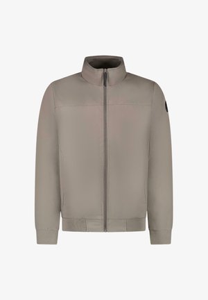 Lichtgrijze jas van gladde stof, met een opstaande kraag, een rits aan de voorkant en geribbelde manchetten en zoom. Voorzien van een zwart accent.