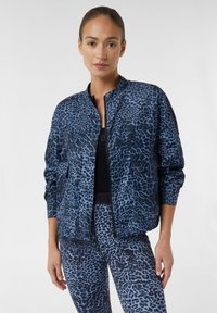 Blue leopard print bomber jacket with a high collar, zip closure, and two front pockets, paired with matching leggings. Smooth fabric texture.