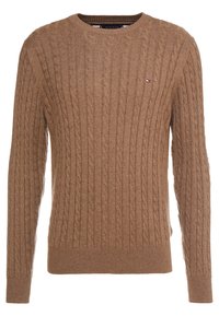Pull en tricot beige avec un col rond, des poignets et un ourlet côtelés. Présente un petit logo sur la poitrine. Fabriqué en maille texturée.