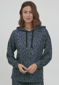 Felpa con cappuccio in stampa leopardata blu, con cordino, maniche lunghe e vestibilità rilassata. Realizzata in tessuto morbido con superficie testurizzata.