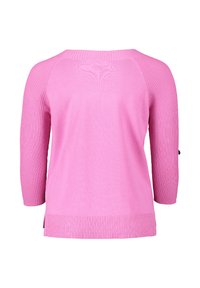 Pink knitted sweater featuring a ribbed texture, three-quarter sleeves, and a rounded neckline with side slits at the hem.