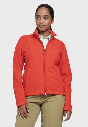 Red fleece jacket with a high collar, zip closure, and side pockets. Features a small logo on the chest. Smooth texture, fitted design.