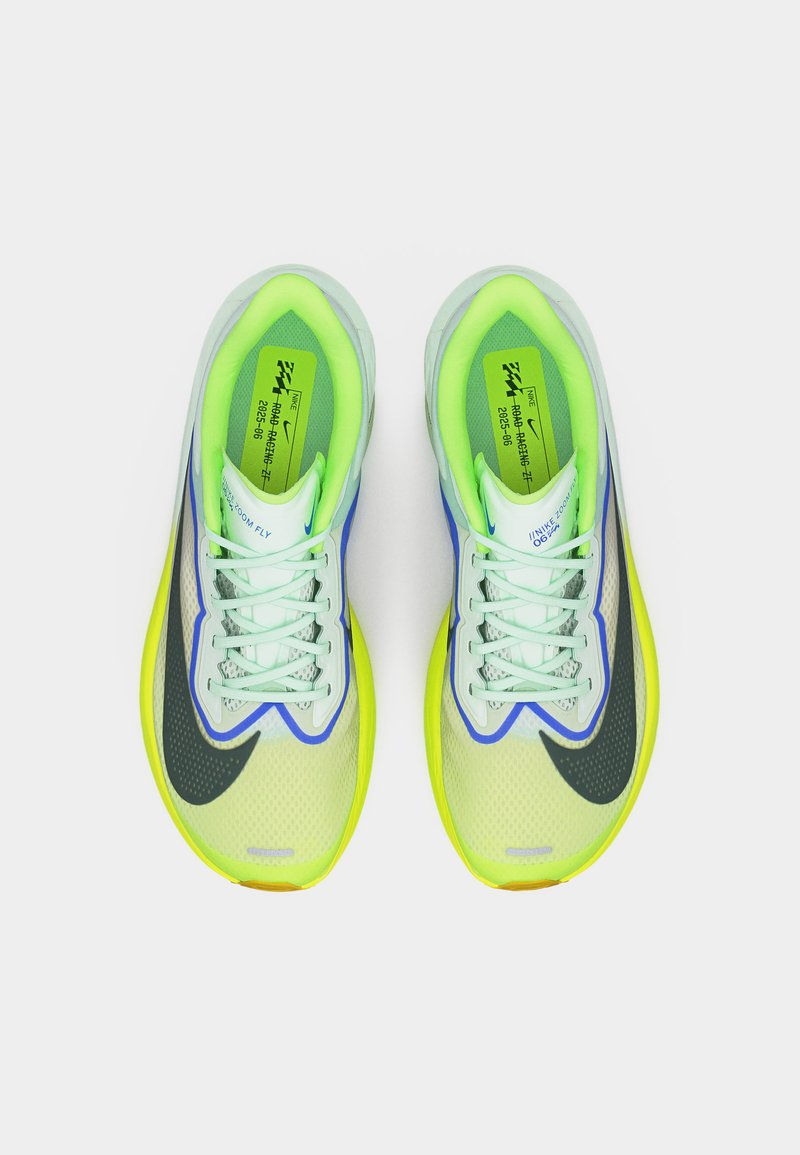 Paire de chaussures de course néon vert et jaune avec le logo Nike noir, lacets blancs et semelles intérieures vertes visibles en vue de dessus.