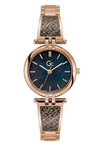 Orologio dorato con quadrante rotondo, dial iridescente scuro e indicatori delle ore allungati. Presenta un bracciale in metallo con un inserto a motivi neri.