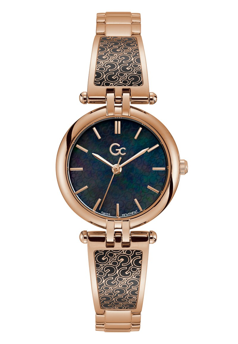 Orologio dorato con quadrante rotondo, dial iridescente scuro e indicatori delle ore allungati. Presenta un bracciale in metallo con un inserto a motivi neri.