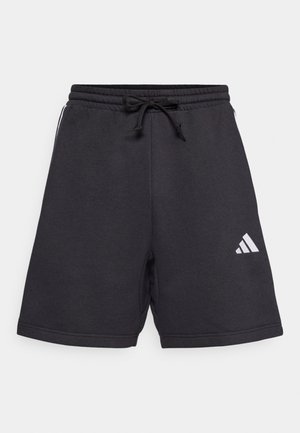 Sorte atletiske shorts med elastisk liv og justerbar snor. Har hvidt diagonalt logo på nederste venstre side. Glat stofstruktur.