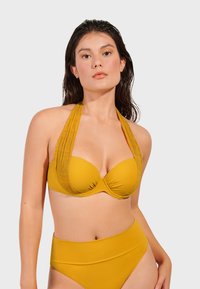 Yellow bikini set featuring a structured halter top with pleated details and high-waisted bottom. Smooth texture with a solid color finish.