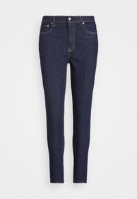 Tummansiniset farkut slim fit -mallilla, perinteisellä viiden taskun suunnittelulla, näkyvällä ompeleella ja napilla sekä vetoketjulla edessä.