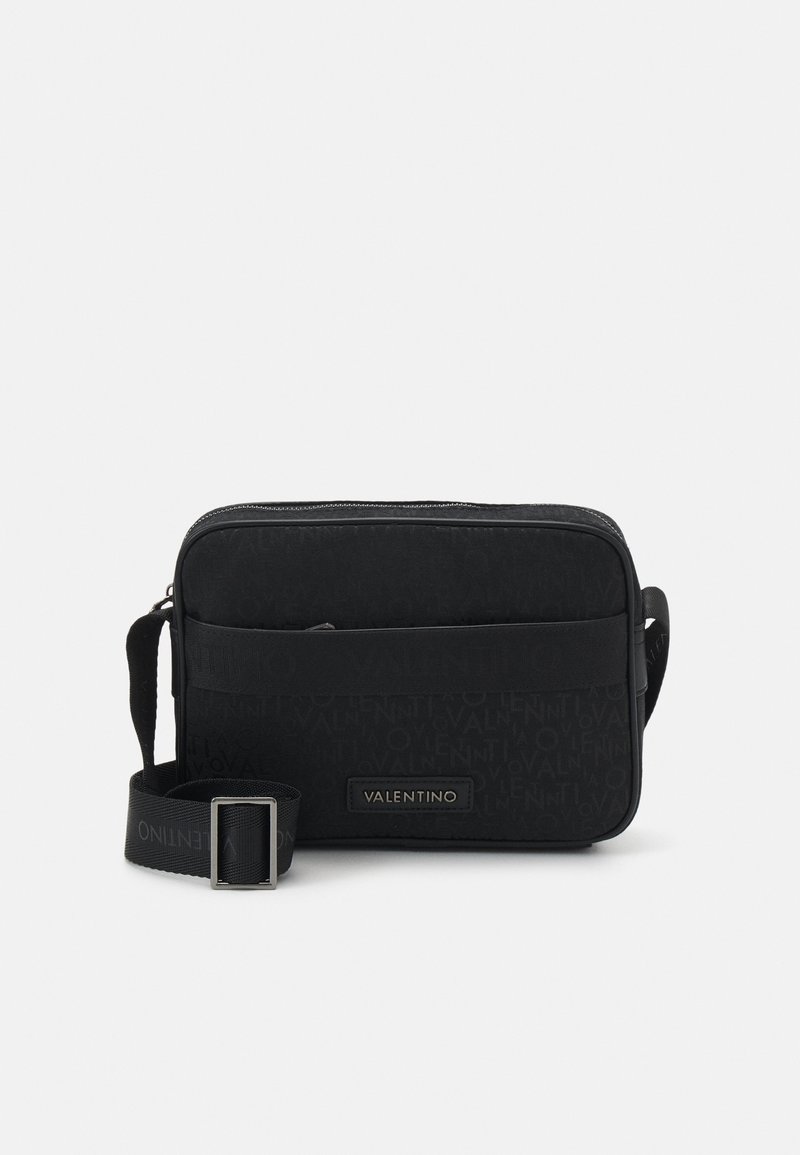 Černá crossbody taška Valentino s embosovaným vzorem loga, přední kapsou na zip a nastavitelným popruhem s kovovou sponou.
