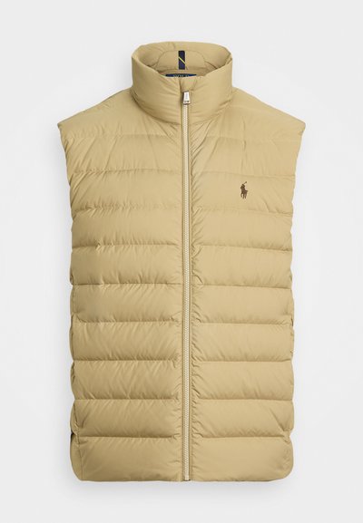 Tan puffer vest with a high neck and zip closure. Features quilted sections and a small logo on the left chest. Smooth, lightweight fabric.