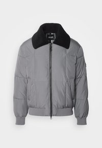 Veste en duvet grise avec un col noir texturé. Comprend une fermeture éclair à l'avant, des poignets côtelés et des poches latérales. Design matelassé sur toute la surface.