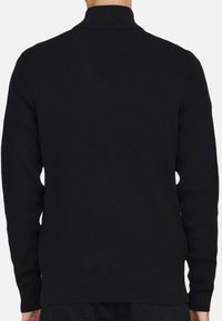 Pull noir à côtes avec un col montant, des manches longues et une coupe droite. La texture est lisse, sans motifs ni accents matériels visibles.