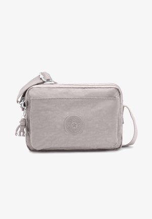 Gray nylon crossbody bag with a textured surface, zip closure, front pocket, a circular logo, and a keychain monkey accent.