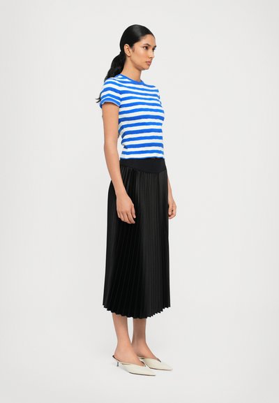 Striped blue and white short-sleeve knit top paired with a black pleated midi skirt and cream pointed flats. Simple, contrasting textures.