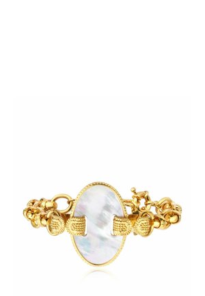 Bracelet en or avec un élément central ovale en nacre et des fermoirs dorés texturés, avec un design à chaîne multi-maillons.