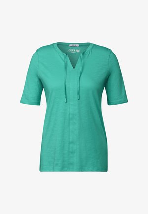 Tunic corta azzurra a maniche corte con scollo a V e dettaglio con coulisse, realizzata in materiale morbido, caratterizzata da una linea dritta e una sottile texture.