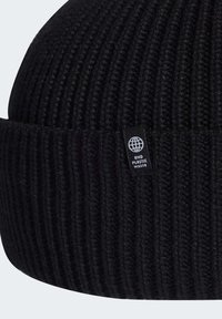 Black knitted beanie with a ribbed texture and a folded cuff. Features a small tag with a globe graphic and the text "END PLASTIC WASTE."