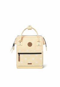 Yellow synthetic backpack with a front zip pocket, decorative sun patterns, dual handles, and a branded leather patch.