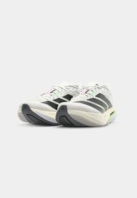 Running shoes with a white mesh upper, black stripes, and pastel accents. Features a textured sole and a cushioned midsole design.