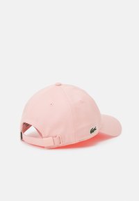 Lacoste UNISEX - Kapa - cherry tree