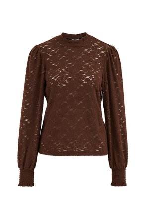 Blouse en dentelle marron à manches longues avec épaules bouffantes et poignets élastiqués, dotée d'un col rond haut et d'un motif floral semi-transparent.