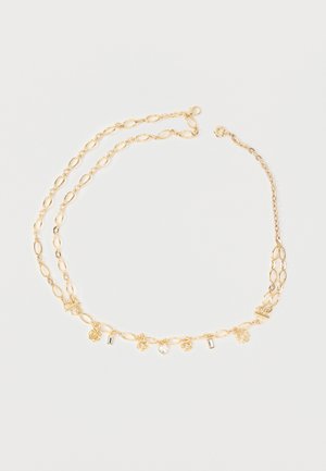 Gold chain necklace with oval links, featuring small charms shaped like flowers, a heart, and rectangular crystals evenly spaced along the chain.