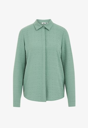 Langärmliges, kragenloses Hemd in Hellgrün, aus strukturiertem Stoff mit kleinen erhabenen Punkten, gerader Schnitt und Knopfverschluss vorne.
