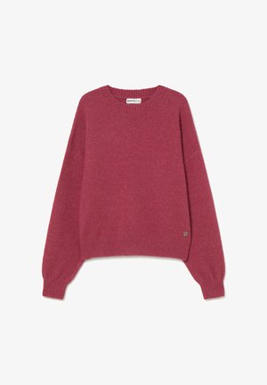 Suéter de cuello en V y manga larga en color rosa intenso. Hecho de material suave con puños y dobladillo acanalados, con una pequeña etiqueta con el logo en el costado.