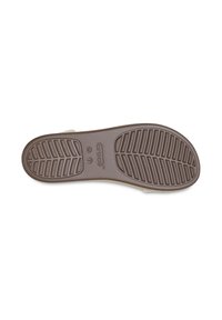 Suela de zapato de goma marrón con un patrón de relieve. Logotipo y etiqueta de tamaño grabados en el talón. Textura suave con forma redondeada.