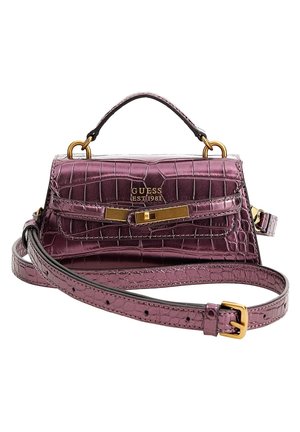Purple crocodile-texture Guess handbag with gold buckle, top handle, and adjustable shoulder strap on white background.