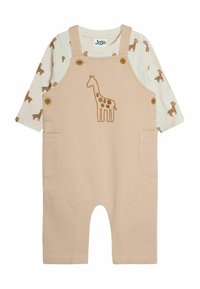 Beige overall met een gestructureerde afwerking, voorzien van een giraffe borduursel; gelaagd met een langemouwen shirt versierd met kleine giraffe prints.