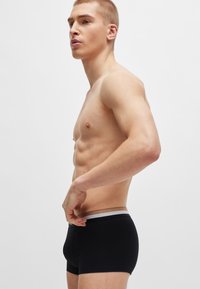 Fekete boxeralsó, kényelmes derékrésszel, amelyen szürke kiegészítők találhatók. Simaságot biztosító szövet, testhezálló kialakítással a karcsú sziluettért.