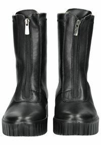 Black leather ankle boots with a smooth finish, featuring dual side zippers, and thick rubber soles with vertical ribbed texture.