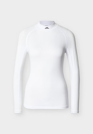 Camiseta de manga larga blanca para surf con tejido liso y elástico. Presenta un cuello alto y costuras planas. Branding minimalista en el cuello.