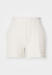 Vita ribbade shorts med resårmidja och en liten Nike-logotyp på vänster fram. Utformade med en smal, åtsittande passform.