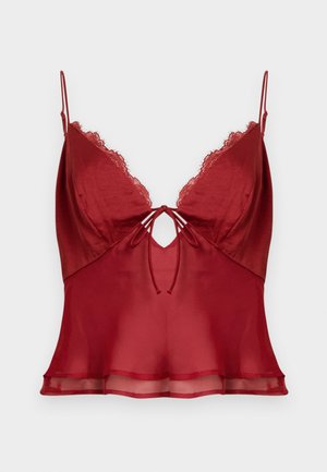 Camiseta de satén rojo con ribete de encaje, que cuenta con tirantes ajustables y un detalle de nudo en la parte delantera. Textura suave con un dobladillo fluido.