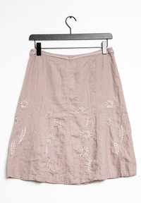 Pink linen skirt featuring floral embroidery with beaded accents, a fitted waistband, and a flared hem with pleats for added volume.